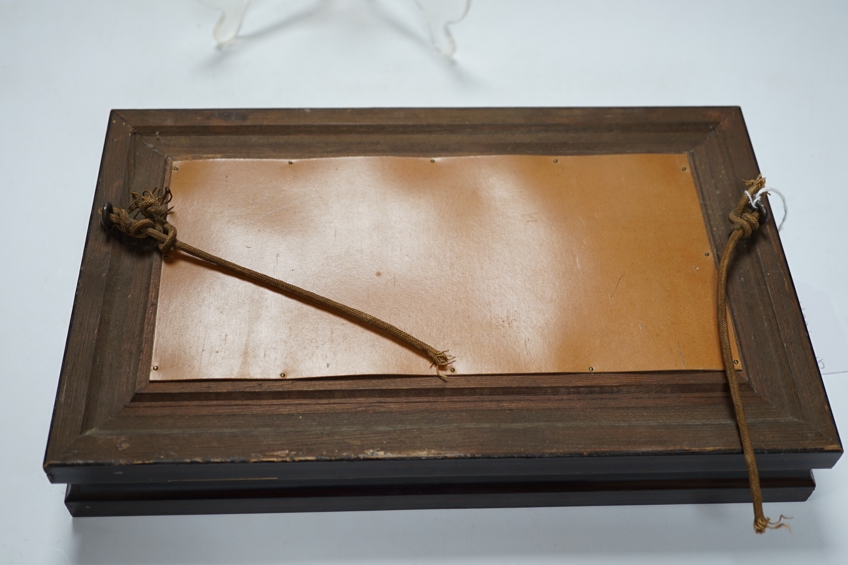A framed Limoges pate sur pate plaque, of a reclining nude with cherubs, 31cm x 19.5cm